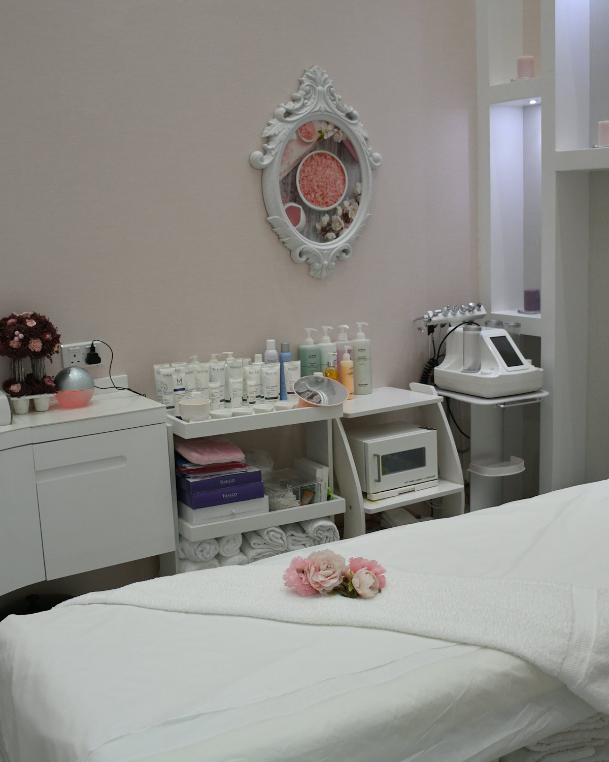 Treatment room with a couch, mirror and shelves of products