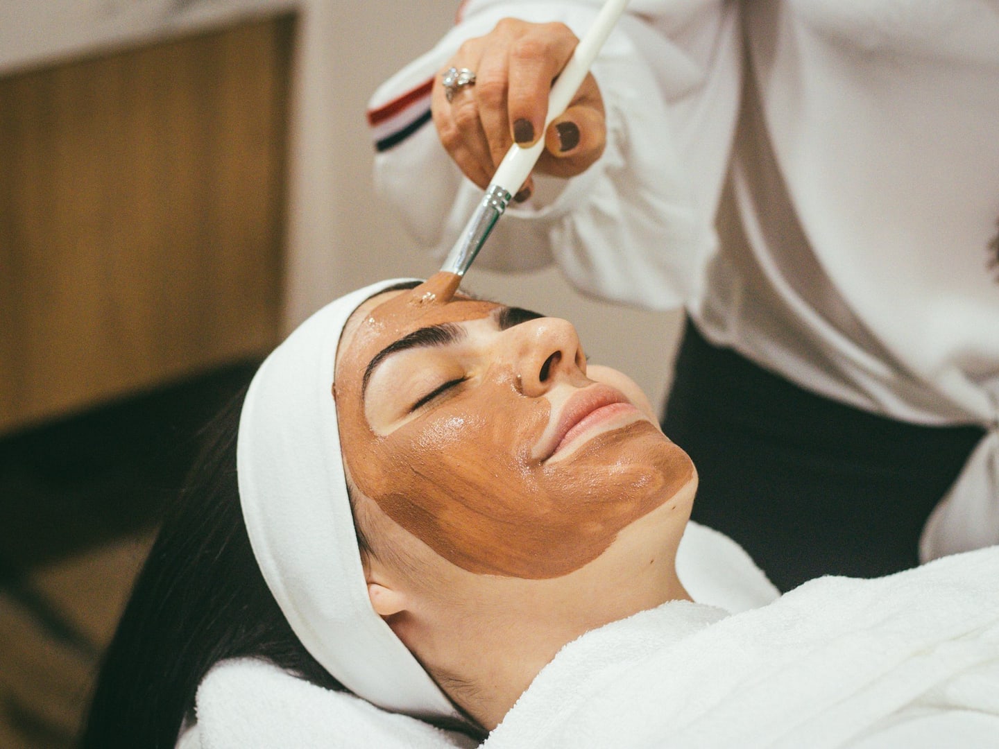 A treatment mask being applied to a patient with a brush