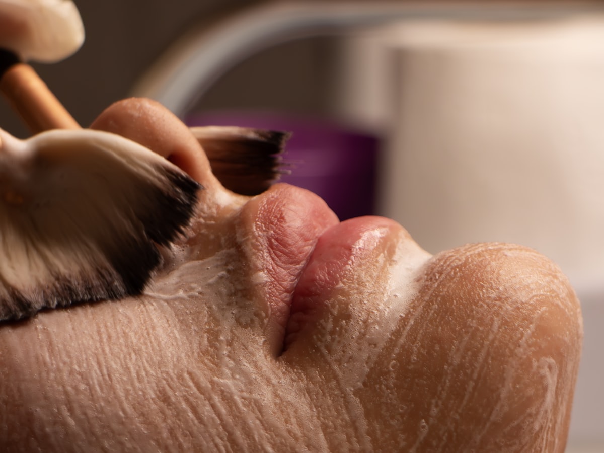 A treatment cream being applied with a brush
